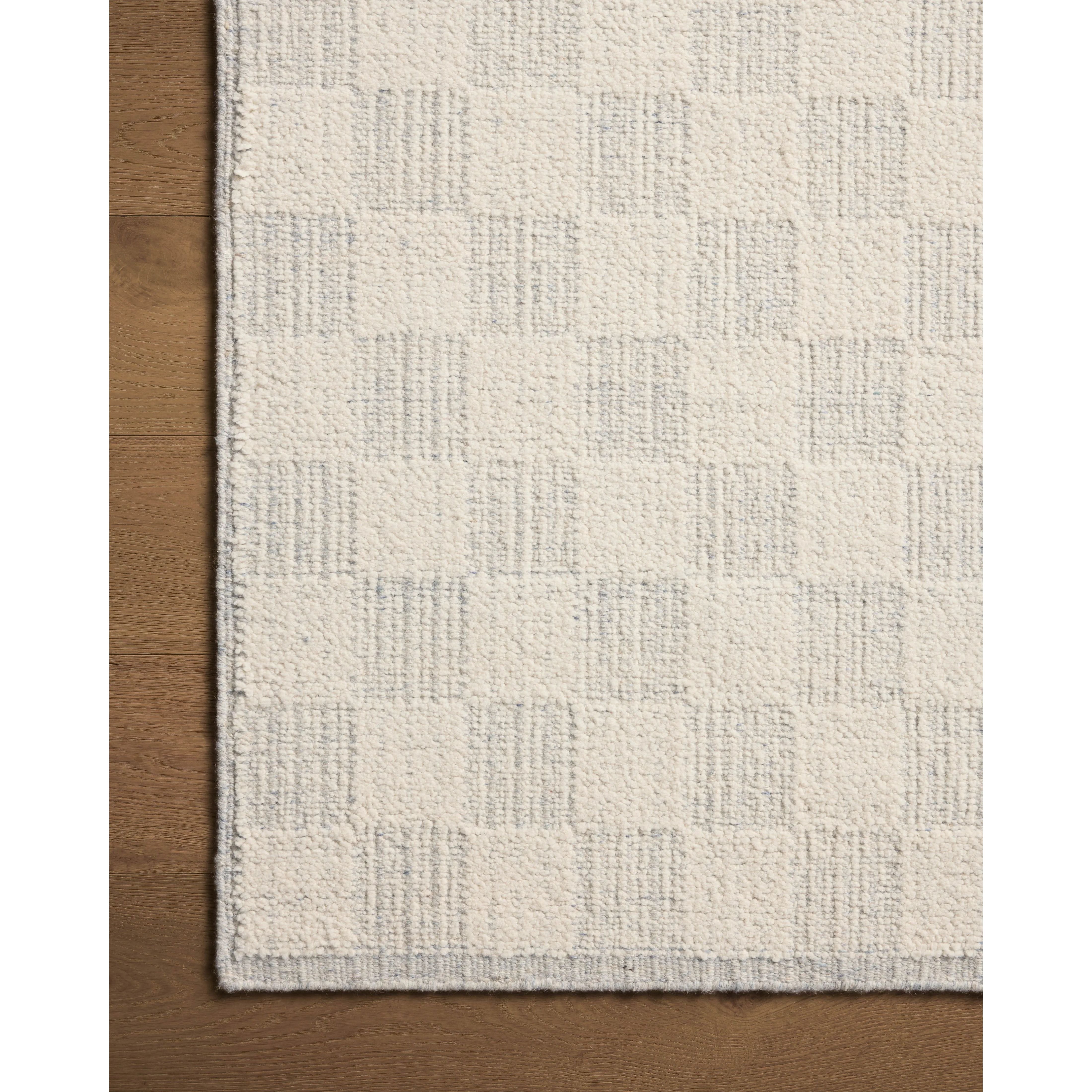 Featuring Brigette Romanek x Loloi Knox Ivory / Sky Rug by Loloi at Amethyst Home. The Knox Ivory / Sky Rug by Brigette Romanek x Loloi is a handwoven area rug with a contemporary checkerboard pattern and a texture reminiscent of a luxurious knit sweater. Made of a blend of wool and cotton that plays with scale and texture, Knox is imbued with cozy luxury that. Amethyst Home provides interior design, new home construction design consulting, vintage area rugs, and lighting in the Austin metro area.