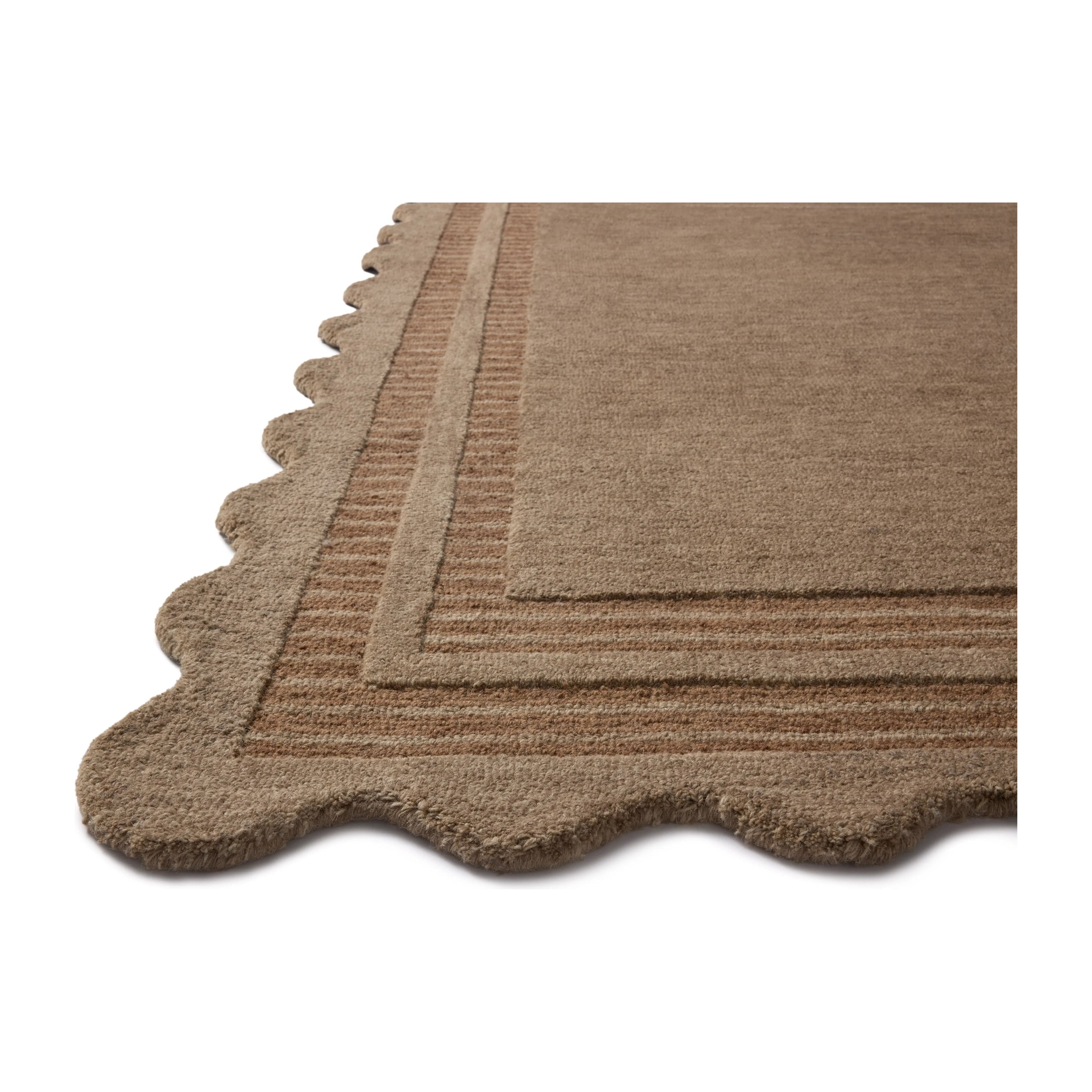 Featuring Chris Loves Julia × Loloi Scottie Mocha / Clay Rug by Loloi at Amethyst Home. The Scottie Collection from Chris Loves Julia x Loloi is a hand-tufted wool area rug with a playful scalloped edge and lower-pile, striped border for a touch of structure. The rugs overall pile is thick and plush, available in easygoing earth tones and neutral colorways. Amethyst Home provides interior design, new home construction design consulting, vintage area rugs, and lighting in the Alpharetta metro area.