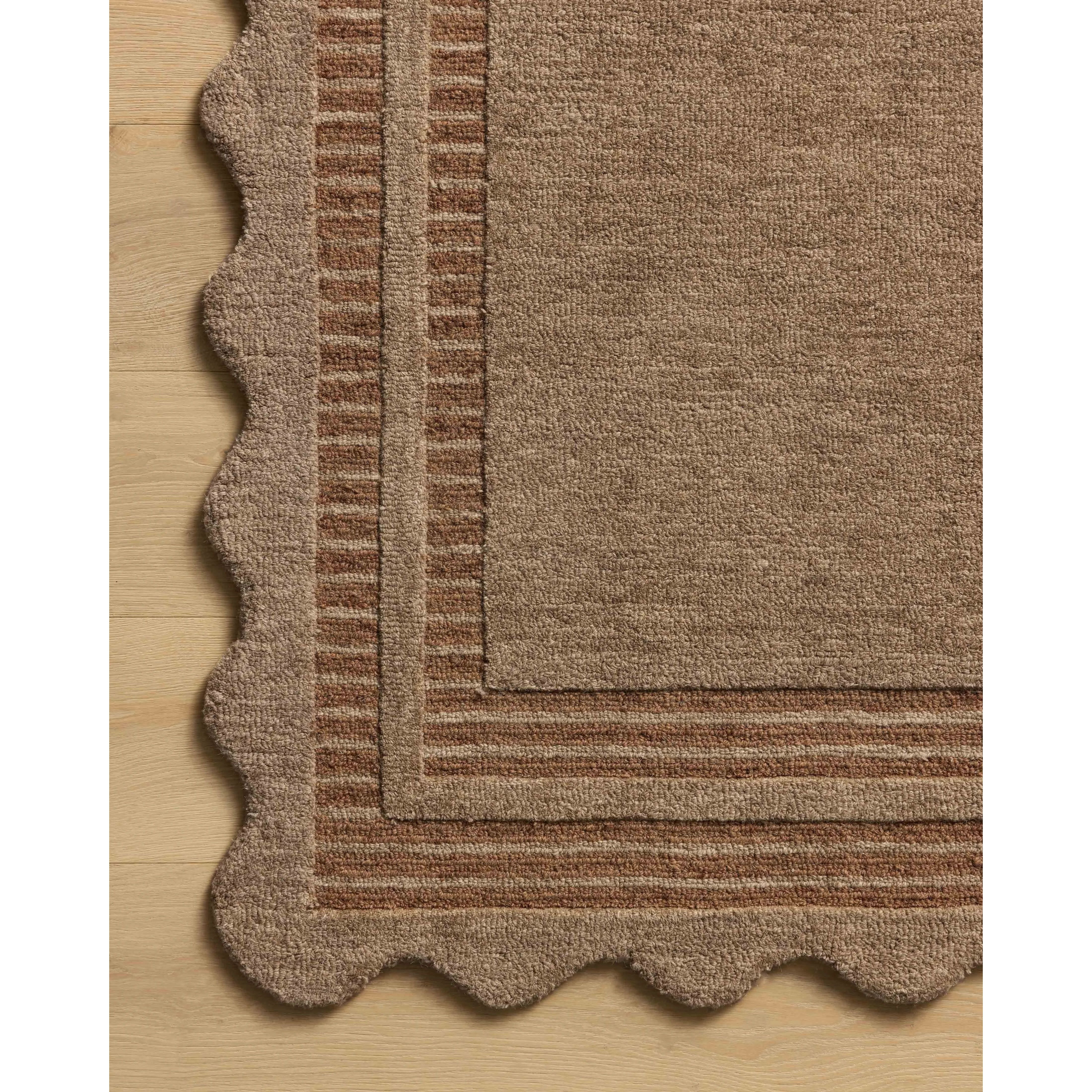 Featuring Chris Loves Julia × Loloi Scottie Mocha / Clay Rug by Loloi at Amethyst Home. The Scottie Collection from Chris Loves Julia x Loloi is a hand-tufted wool area rug with a playful scalloped edge and lower-pile, striped border for a touch of structure. The rugs overall pile is thick and plush, available in easygoing earth tones and neutral colorway. Amethyst Home provides interior design, new home construction design consulting, vintage area rugs, and lighting in the Kansas City metro area.