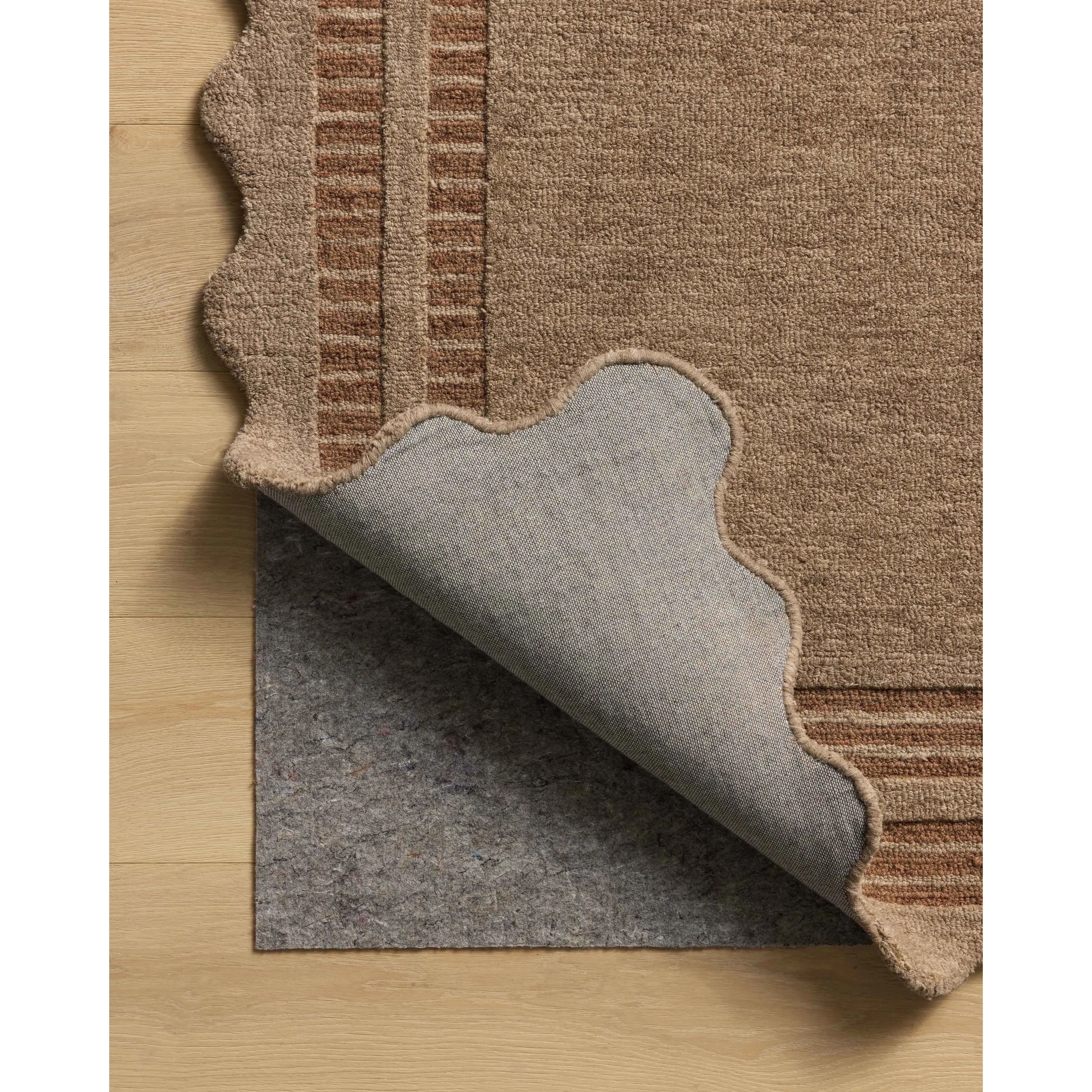 Featuring Chris Loves Julia × Loloi Scottie Mocha / Clay Rug by Loloi at Amethyst Home. The Scottie Collection from Chris Loves Julia x Loloi is a hand-tufted wool area rug with a playful scalloped edge and lower-pile, striped border for a touch of structure. The rugs overall pile is thick and plush, available in easygoing earth tones and neutral colorw. Amethyst Home provides interior design, new home construction design consulting, vintage area rugs, and lighting in the Newport Beach metro area.