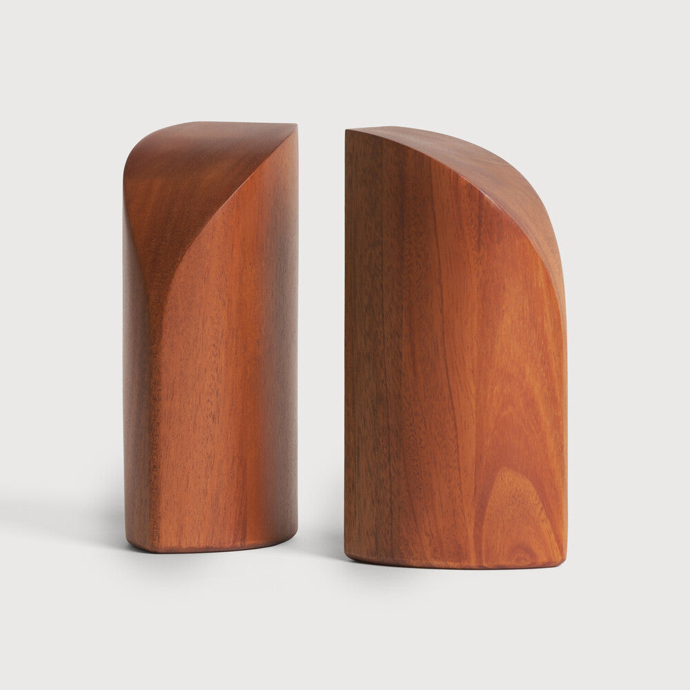 Featuring Pi Mahogany Book Ends by Ethnicraft at Amethyst Home. The PI collection honours nature’s design by keeping the strength, curves and lines, as nature intended. Each PI book end is finished by hand to ensure that the individual character of the wood is respected. Interesting shapes are discovered in this sleek and stylish, polished imperfect, finish. Designed by Alain va. Amethyst Home provides interior design, new construction, custom furniture, and area rugs in the Kansas City metro area