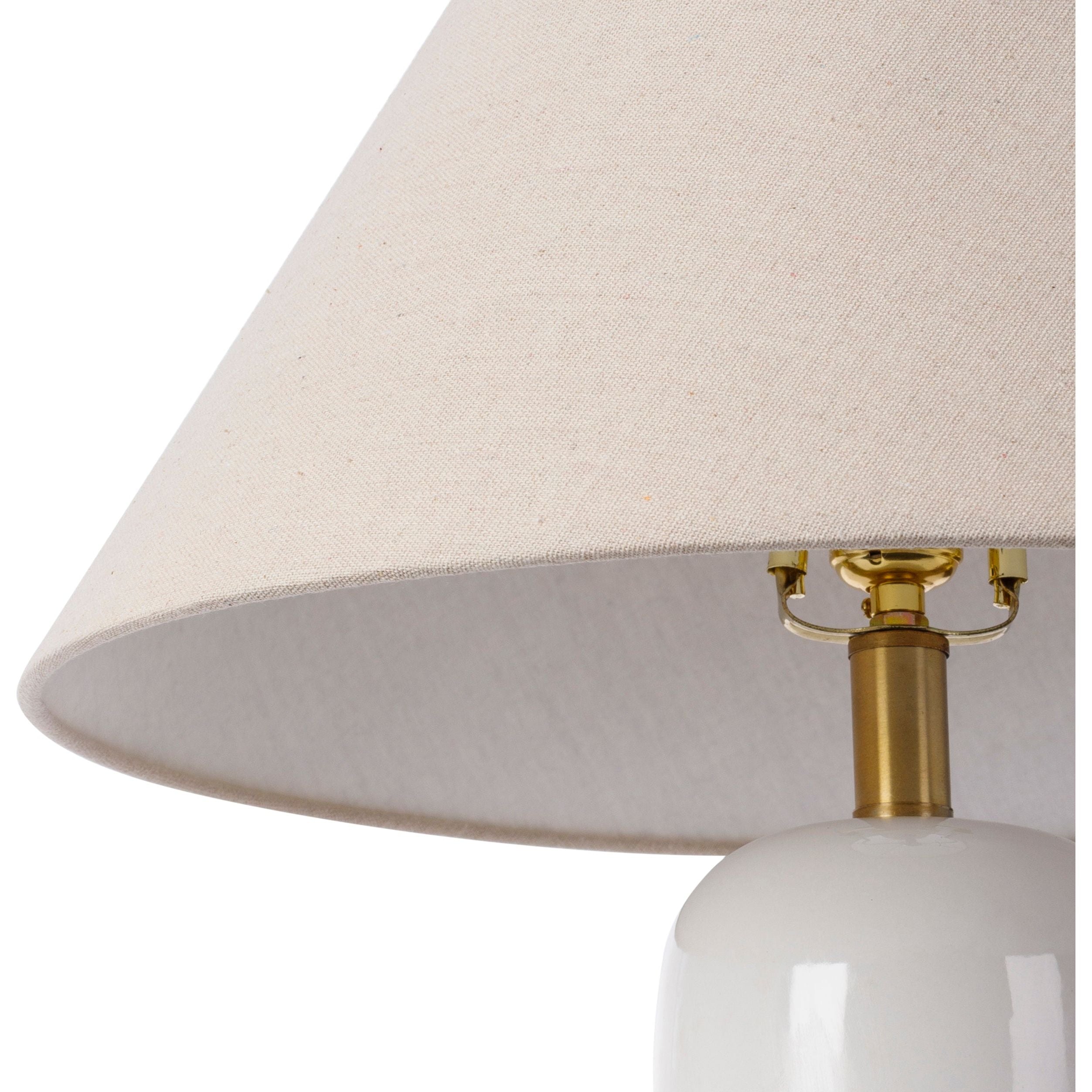 Featuring Vespa Table Lamp by Surya at Amethyst Home. A pretty matte white base with a creamy linen shade -- the Vespa lamp is sweet and subtle.  And the top little brass knob is precious!
Overall Dimensions: 26"H x 18"W x 18"D
Switch Type: On/OffNumber of bulbs: 1E-26/60 WUL CUL Certified.  Amethyst Home provides interior design, new home construction design consulting, vintage area rugs, and lighting in the Charlotte metro area.