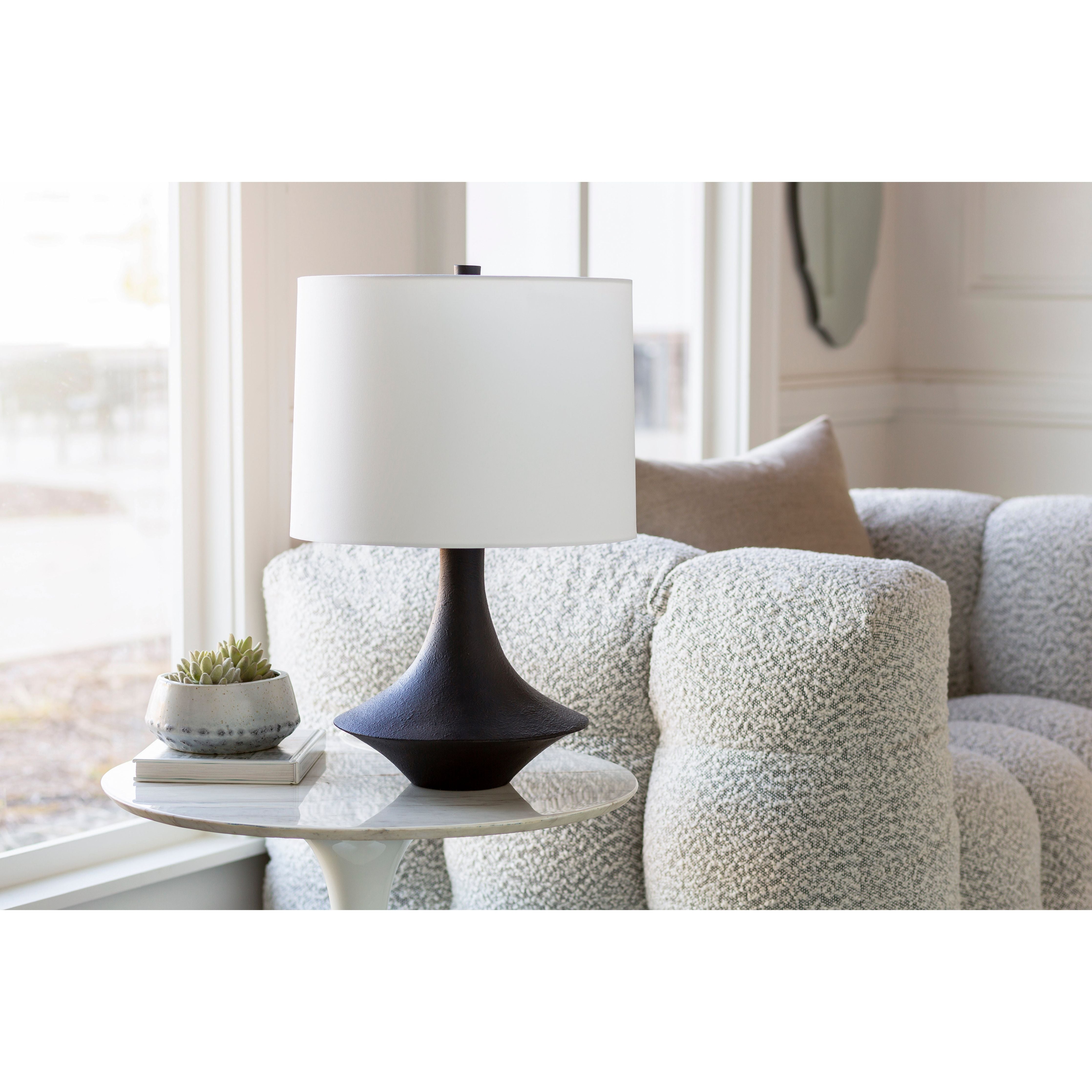 Featuring Brya Table Lamp by Surya at Amethyst Home. A touch of mid-century with a textured, interesting base -- the Bryant lamp is an Amethyst essential.
Overall Dimensions: 23"H x 12"W x 15"DSwitch Type: 3-WayNumber of bulbs: 1E-26/100 WUL CUL Certified.  Amethyst Home provides interior design, new home construction design consulting, vintage area rugs, and lighting in the Dallas metro area.
