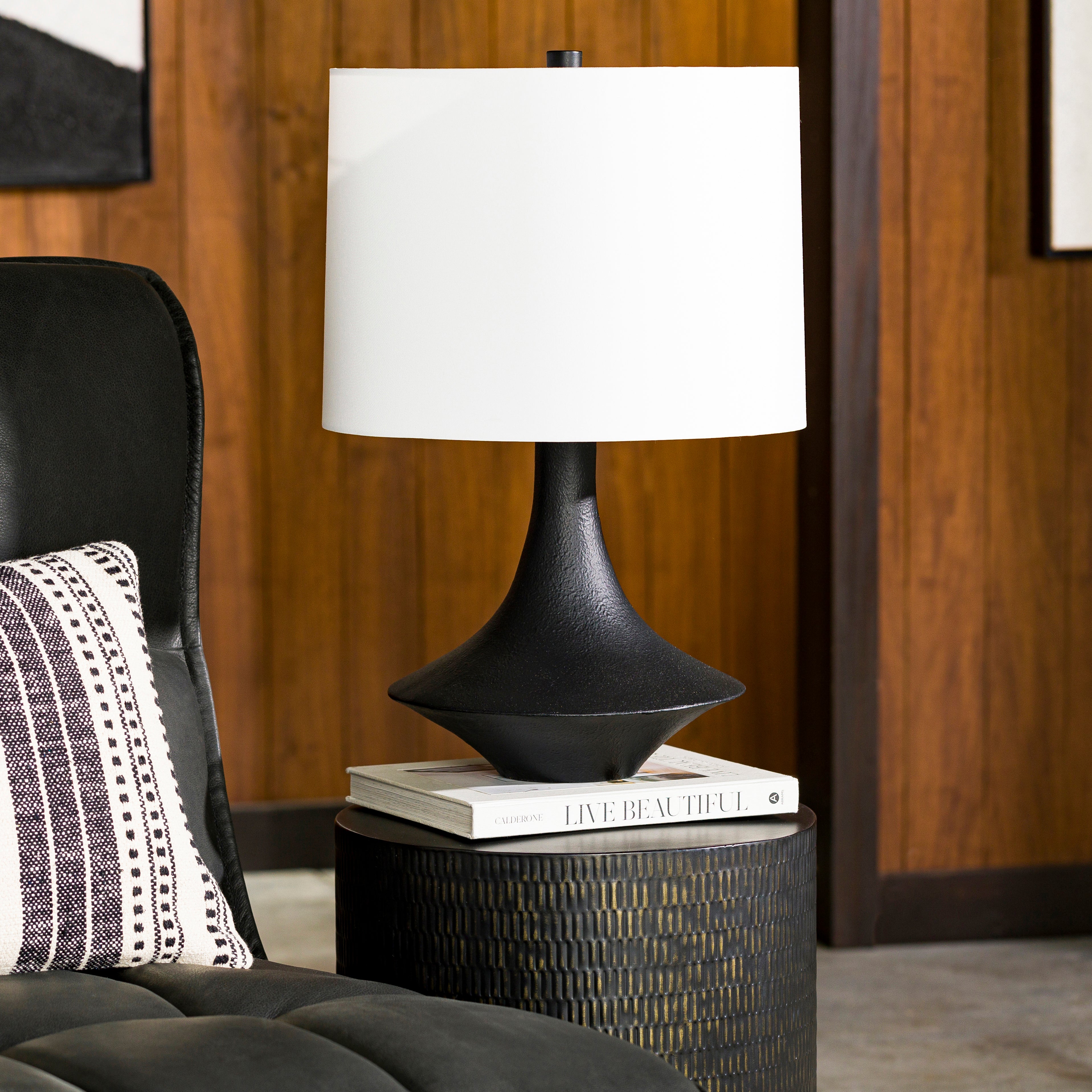 Featuring Brya Table Lamp by Surya at Amethyst Home. A touch of mid-century with a textured, interesting base -- the Bryant lamp is an Amethyst essential.
Overall Dimensions: 23"H x 12"W x 15"DSwitch Type: 3-WayNumber of bulbs: 1E-26/100 WUL CUL Certified.  Amethyst Home provides interior design, new home construction design consulting, vintage area rugs, and lighting in the Kansas City metro area.