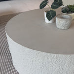 A textured, white concrete coffee table perfect for modern and wabi sabi style.  The table has a matte texture and is perfect for indoors or outdoors.Overall Dimensions: 48.00"w x 48.00"d x 16.25"hWeight : 277.78 lbsMaterials : Concrete Amethyst Home provides interior design, new home construction design consulting, vintage area rugs, and lighting in the Winter Garden metro area.