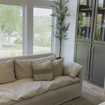 An Amethyst essential: dreamy feather top cushion covers a full upholstered frame.  Slipcovered in an ethereal white linen machine washable slipcover — made just for you in North Carolina. Amethyst Home provides interior design, new home construction design consulting, vintage area rugs, and lighting in the Salt Lake City metro area.