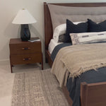 A simple, heavy wood bed frame with a removable sling cushion in a neutral fabric with blind button tufting. Choose the all-wood look or opt for a softer look with the pillow. The cushion is reinforced at the corners for added durability and easily removed for cleaning. Amethyst Home provides interior design, new home construction design consulting, vintage area rugs, and lighting in the Scottsdale metro area.