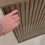 Designed by Thomas Bina and Ronald Sasson, a design partnership blending both modern minimalist and Brazilian influences. Crafted from solid oak, this clean-lined dresser features vertical reed detailing on the drawer fronts with wooden pull detailing on the outer edges. Drawers are finished with soft close under-mount drawer glides. Amethyst Home provides interior design, new home construction design consulting, vintage area rugs, and lighting in the Charlotte metro area.