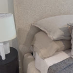 Modern, clean shaping meets inflated comfort with this padded, upholstered bed frame in a textural boucle-like pattern.  Text(251) 257-7986 for quick product details.Overall Dimensions: 92.25"W x 89.25"L x 48"H Amethyst Home provides interior design, new home construction design consulting, vintage area rugs, and lighting in the Houston metro area.