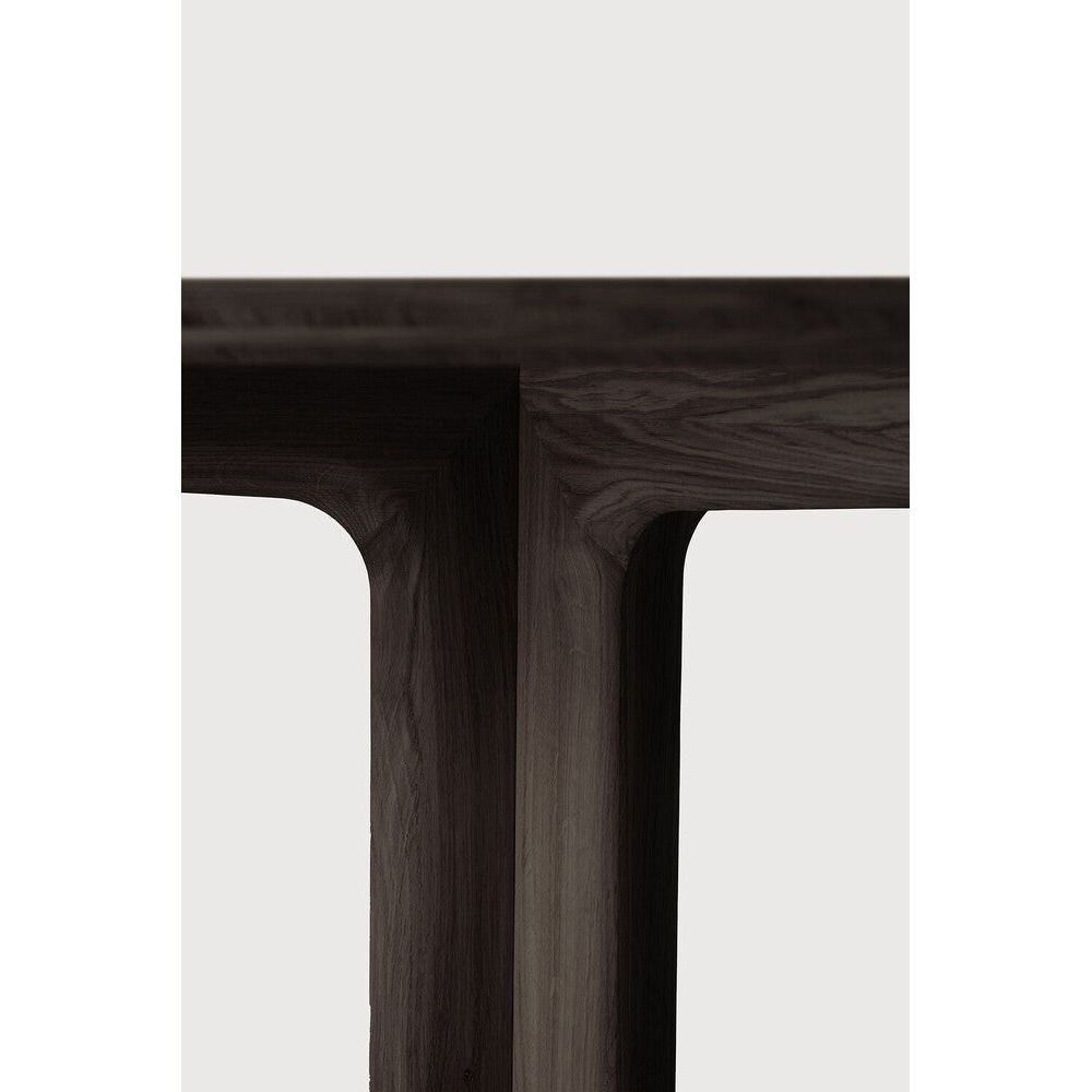 Featuring Corto Square Brown Oak Dining Table by Ethnicraft at Amethyst Home. Inspired by the vaults within grand architectural designs, the Corto's central-footed base provides both visual interest and practical stability with less leg disturbance for your guests. The solid oak tabletop is crafted into the perfect shape, with unique rounded corners to.  Amethyst Home provides interior design, new home construction design consulting, vintage area rugs, and lighting in the Winter Garden metro area.