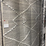 The Irvine Charcoal area rug from Loloi is hand-woven of wool, cotton, and polyester by artisans for a super comfortable rug. This rug is made from variegated yarns, fluffy bouclé texture, and has a twisted fringe border.  The Irvine rug lays a cozy foundation in a bedroom, living room, or family room for the perfect casual retreat. The rug has gorgeous tones of black, ivory, and pops of yellow for a cozy look. Crafted by Loloi for ED Ellen DeGeneres.  Hand Woven 81% Wool | 10% Cotton | 9% Polyester IRV-01