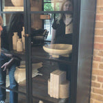 Store it in style with this Breya Cabinet - Black. Made from black-finished iron, beautifully arched cabinetry features glass-front doors, ideal for storing and displaying favorite books, photos, keepsakes, and more.  Overall Dimensions: 40.00"w x 16.25"d x 86.75"h