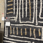 The Naomi Charcoal / Natural Area Rug is hand-knotted of wool and cotton by artisans in India. Naomi offers bold designs with earthy hues and features a high-low pile that adds depth and dimension, making each piece create the illusion of movement. A perfect rug for your living room, entryway, or other  Hand Knotted 89% Wool | 11% Cotton NAO-05 Charcoal/Natural