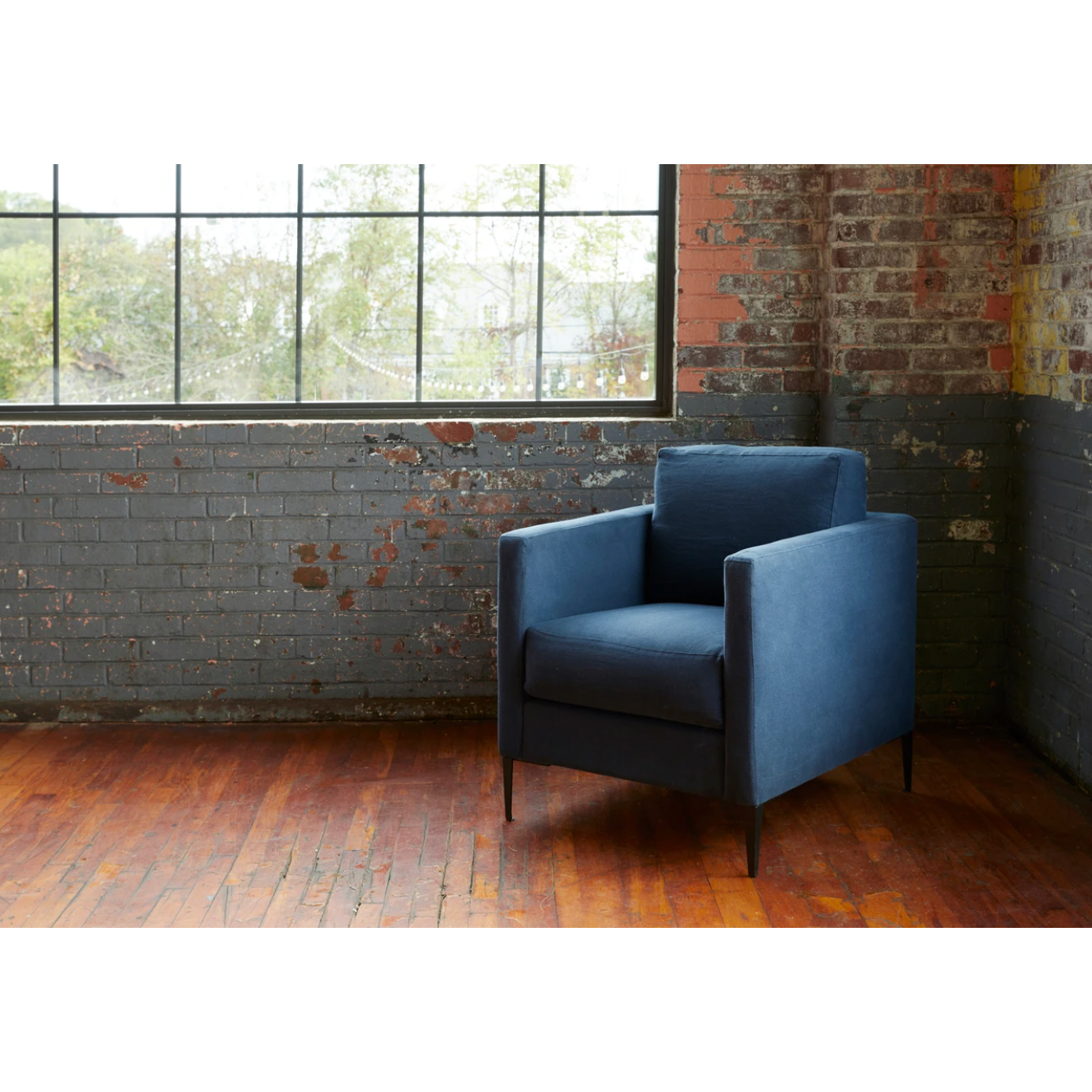 Featuring Benedict Upholstered Chair - Custom by Cisco Brothers at Amethyst Home. The Benedict Chair - Custom by Cisco Brothers is a modern design with clean lines and sleek metal legs in black rust. It has a fresh and functional aesthetic with no-sag support. As a small scale sofa, its ideal for apartment living and suitable for any occasion. Photographed in. Amethyst Home provides interior design, new home construction design consulting, vintage area rugs, and lighting in the Houston metro area.
