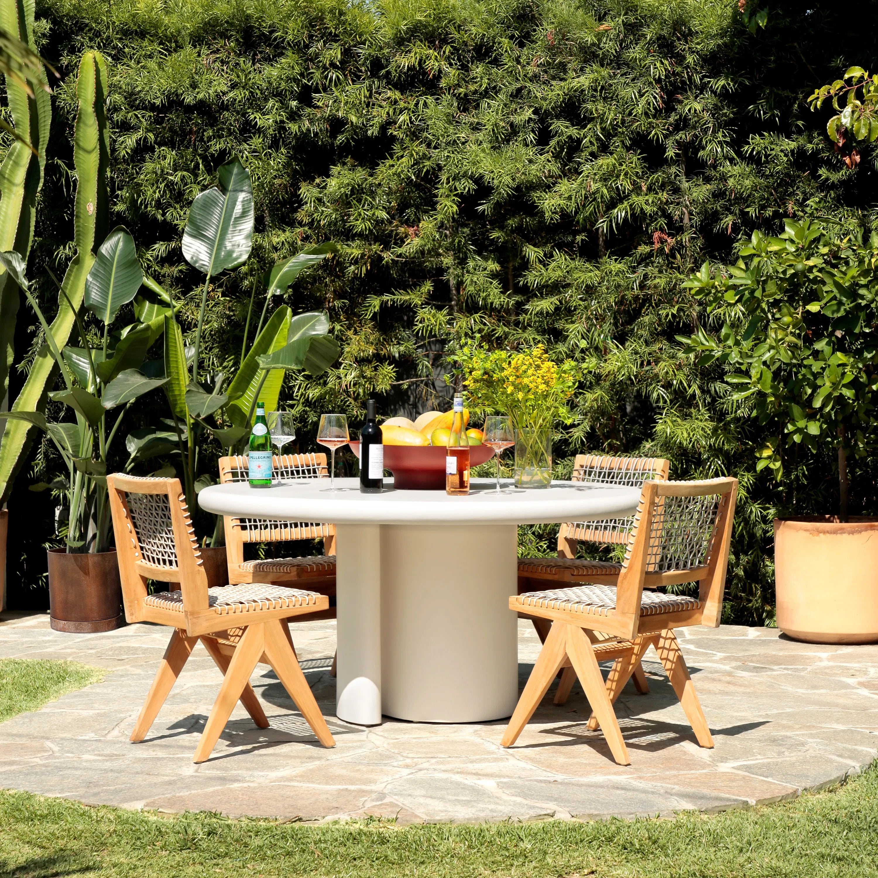 Featuring Marco White Concrete Dining Table by Dovetail at Amethyst Home. A contemporary and modern coastal design that adds exceptional detail to anywhere it's placed. It features a stylish contrast between clean lines and gently rounded edges. The exquisite white finish compliments the streamlined silhouette that instantly elevates a sophisticated dinner. T. Amethyst Home provides interior design, new home construction design consulting, vintage area rugs, and lighting in the Seattle metro area.