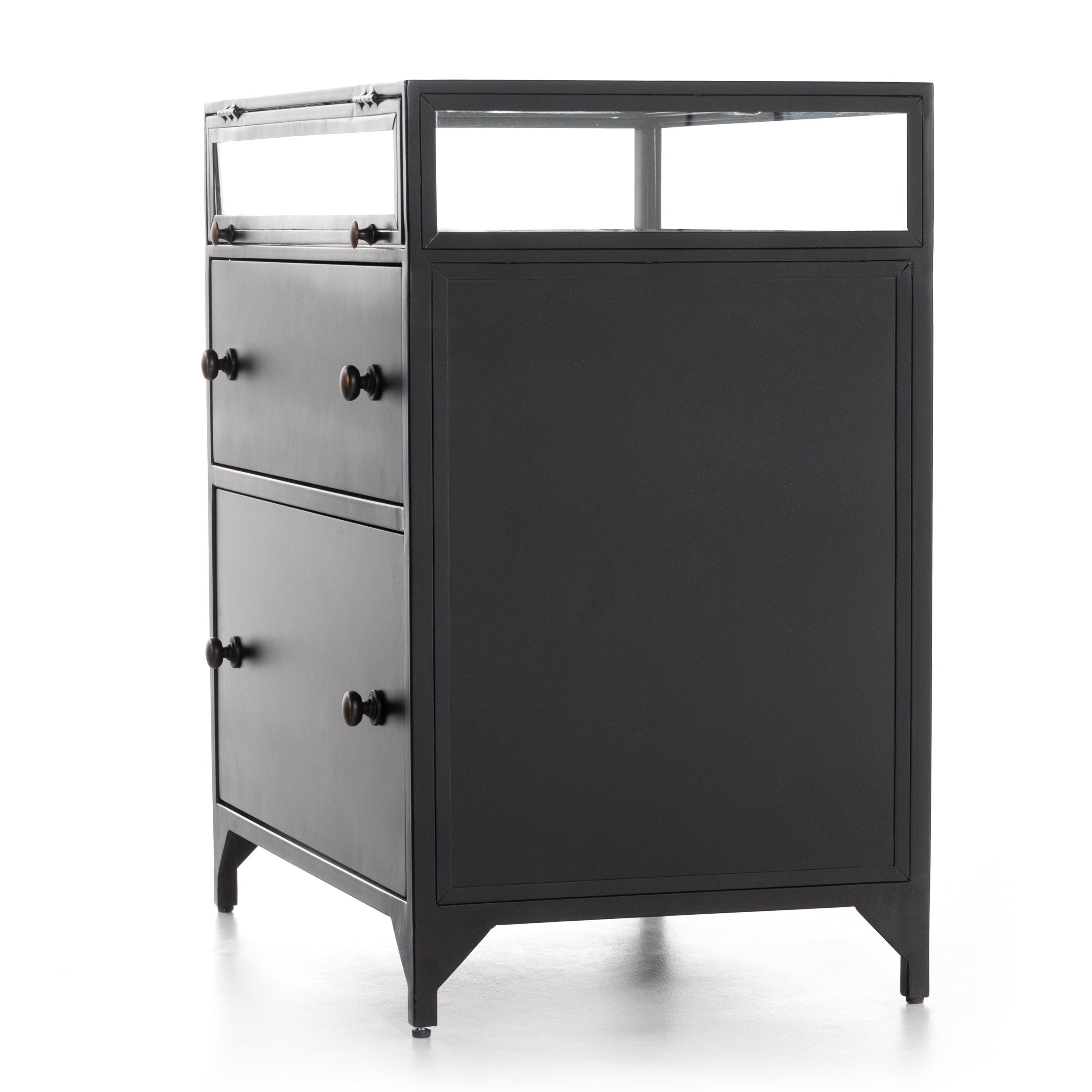 Featuring Shadow Box Nightstand by Four Hands at Amethyst Home. This Shadow Box Nightstand is finished in a gorgeous matte black. We love that the glass top allows you to showcase your favorite jewelry or family keepsake, while the two spacious drawers give you storage space. The knobs are finished in bronze to give this piece a sleek contrast. 
Overall Dimens.  Amethyst Home provides interior design, new home construction design consulting, vintage area rugs, and lighting in the Omaha metro area.