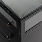 Featuring Shadow Box Nightstand by Four Hands at Amethyst Home. This Shadow Box Nightstand is finished in a gorgeous matte black. We love that the glass top allows you to showcase your favorite jewelry or family keepsake, while the two spacious drawers give you storage space. The knobs are finished in bronze to give this piece a sleek contrast. 
Overall Dimens.  Amethyst Home provides interior design, new home construction design consulting, vintage area rugs, and lighting in the Omaha metro area.