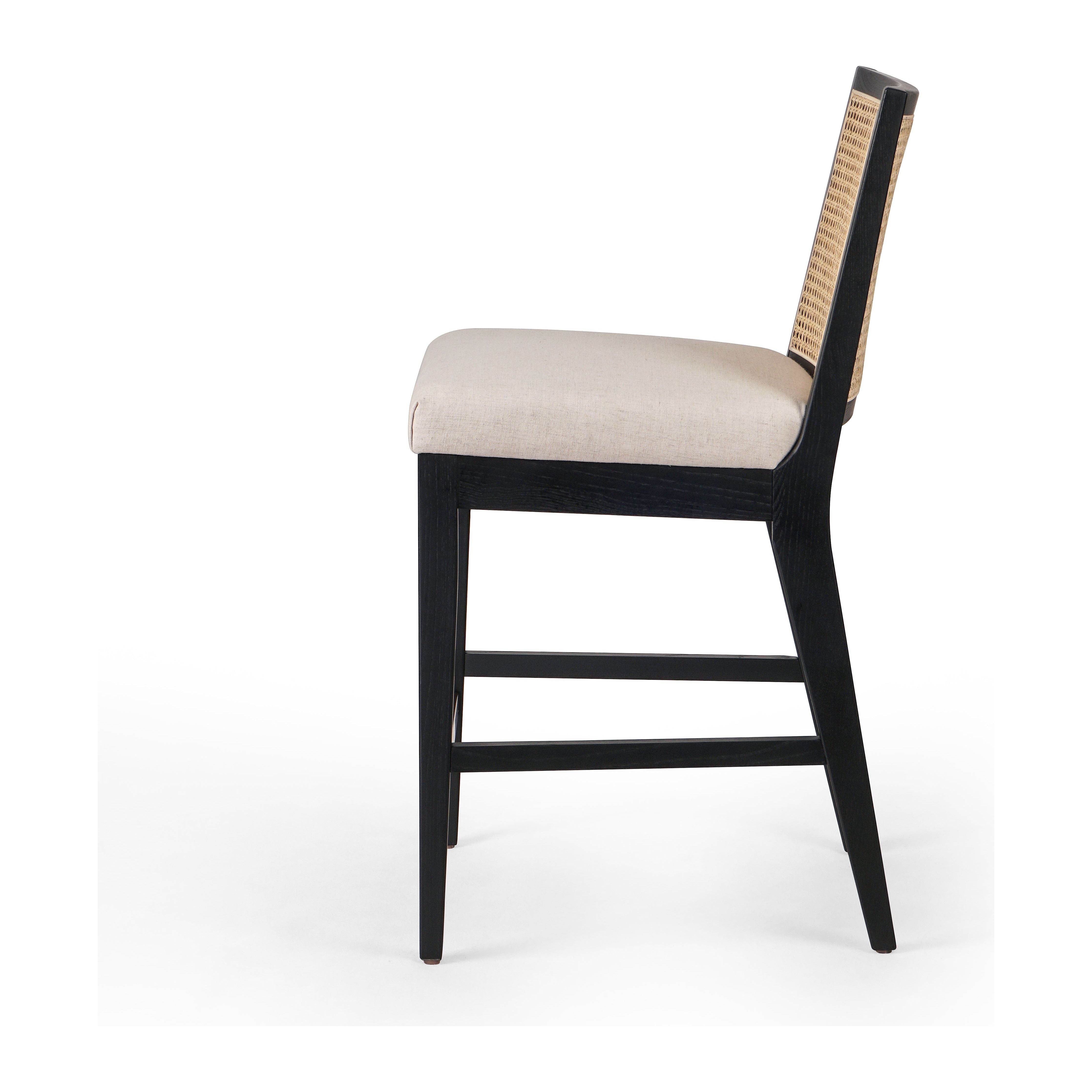 Featuring Antonia  Armless Dining Stool Stool by Four Hands at Amethyst Home. Light-toasted parawood frames a textural inlay of natural cane for a clean, monochromatic look, with seating of performance fabric for smart sensibility. Perfectly sized for the counter, with a brass kick plate for comfort and contrast. Performance fabrics are specially created to withstand spills, st. Amethyst Home provides interior design, new construction, custom furniture, and area rugs in the Kansas City metro area.