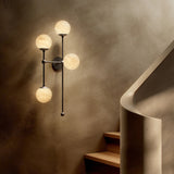 Featuring Armstrong Black Gunmetal Marbled Matte Glass 4 L Sconce by Four Hands at Amethyst Home. Marbled glass spheres seem to extend and reach across smooth brass rods. Each globe is individually blown, shaped and sculpted by hand through a one-hour process. The finish on the brass frame is achieved through a specialized process that turns the brass in. Amethyst Home provides interior design, new home construction design consulting, vintage area rugs, and lighting in the Laguna Beach metro area.