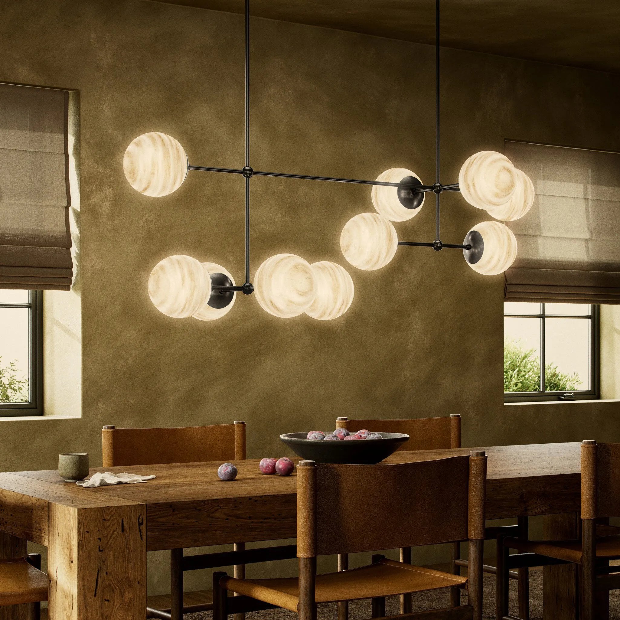 Featuring Armstrong Black Gunmetal Marbled Matte Glass Linear Chandelier by Four Hands at Amethyst Home. Marbled glass spheres seem to extend and reach across smooth brass rods. Each globe is individually blown, shaped and sculpted by hand through a one-hour process. The finish on the brass frame is achieved through a specialized process that turns the brass in. Amethyst Home provides interior design, new home construction design consulting, vintage area rugs, and lighting in the Miami metro area.