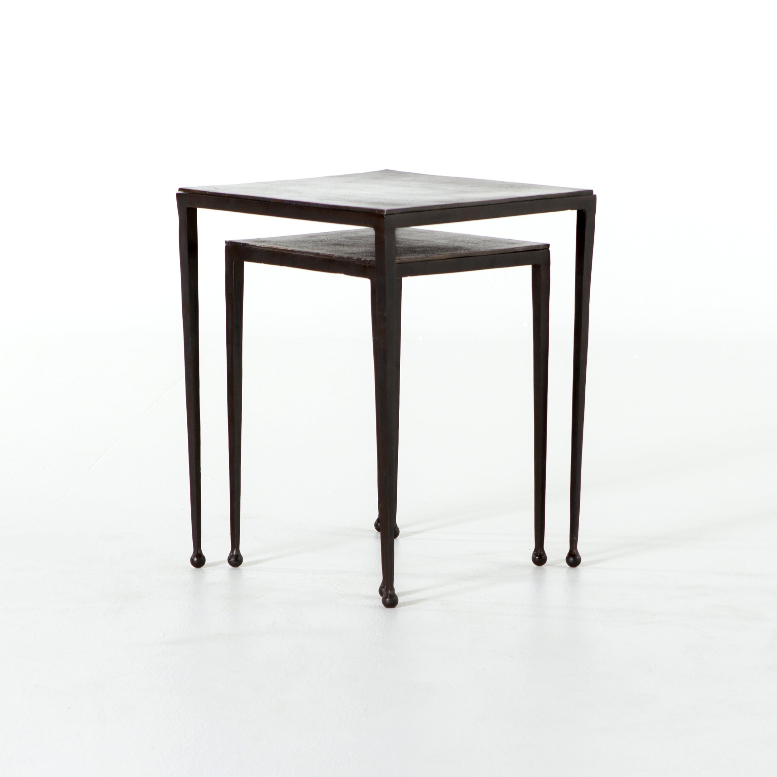 Featuring Dalston Antique Rust Nesting End Tables by Four Hands at Amethyst Home. Slender styling adopts depth from swirls of antique tones. Tapered legs with rounded feet bring balanced footing to streamlined shaping. Aluminum tops are squared-off and finished in a rich rust.   Large nesting table measures 16"W x 21.25"H. Small table measures 12.5"W x 18.25"H.
Collection: Marlow. Amethyst Home provides interior design, new construction, custom furniture, and area rugs in the Portland metro area.