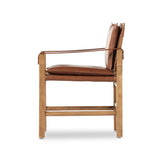 Featuring Lenz Sonoma Chestnut Dining Armchair by Four Hands at Amethyst Home. Inspired by a vintage safari-style frame, this dining chair is defined by the fluid strap arms. Semi-attached cushions in rich chestnut leather, finished with button tufting details. Parawood frame and brass details add warmth and texture.Overall Dimensions: 25"W x 23"L x 34". Amethyst Home provides interior design, new home construction design consulting, vintage area rugs, and lighting in the Newport Beach metro area.