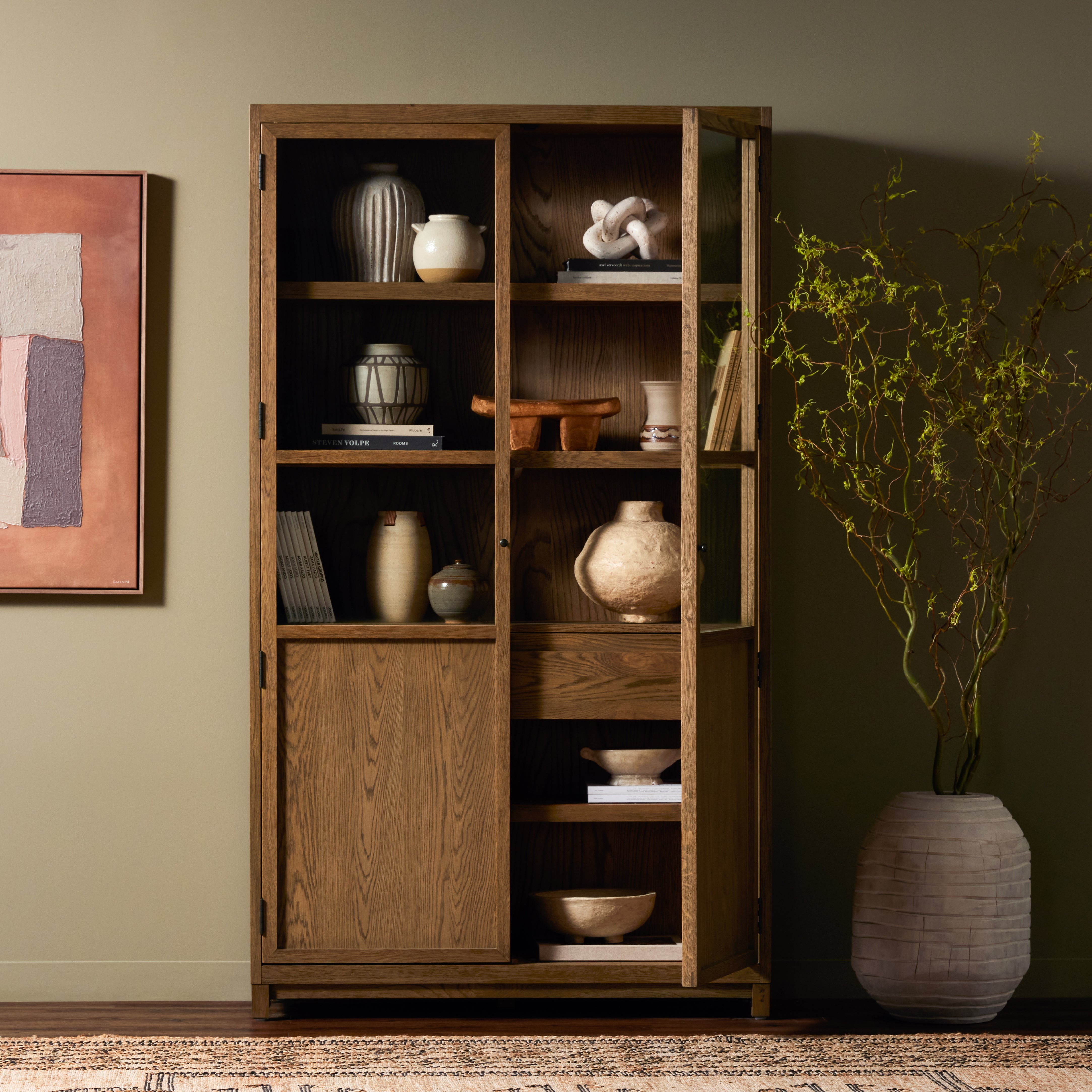 Featuring Millie Drifted Panel & Glass Door Cabinet by Four Hands at Amethyst Home. Drifted oak frames the interior shelving of this cabinet. Glass doors allow for prized possessions to dazzle on full display while spacious cabinets add out-of-view storage.Overall Dimensions: 47.25"W x 17.75"L x 82.75"H
Collection: IrondaleColors: Drifted Oak Solid ,Drifted Oak Veneer ,Tempered. Amethyst Home provides interior design, new construction, custom furniture, and area rugs in the Kansas City metro area.