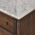 Featuring Odette Antique Belgium Bleach Marble Nightstand by Four Hands at Amethyst Home. Capturing the charm of vintage French storage, this solid mango wood nightstand stands tall with a polished marble top and softened ogee edges. Three spacious drawers are fitted with classic brass-button hardware. Natural marks and cracks are characteristic of the reclaime. Amethyst Home provides interior design, new home construction design consulting, vintage area rugs, and lighting in the Tampa metro area.