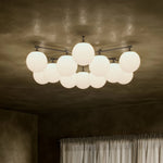 Featuring Orion Black Gunmetal Round Chandelier by Four Hands at Amethyst Home. Matte glass spheres seem to extend and reach across smooth brass rods. Each globe is individually blown, shaped and sculpted by hand through a one-hour process. Matte globes are specially manufactured to evenly diffuse light. The finish on the brass frame is achieved through a s. Amethyst Home provides interior design, new home construction design consulting, vintage area rugs, and lighting in the Calabasas metro area.
