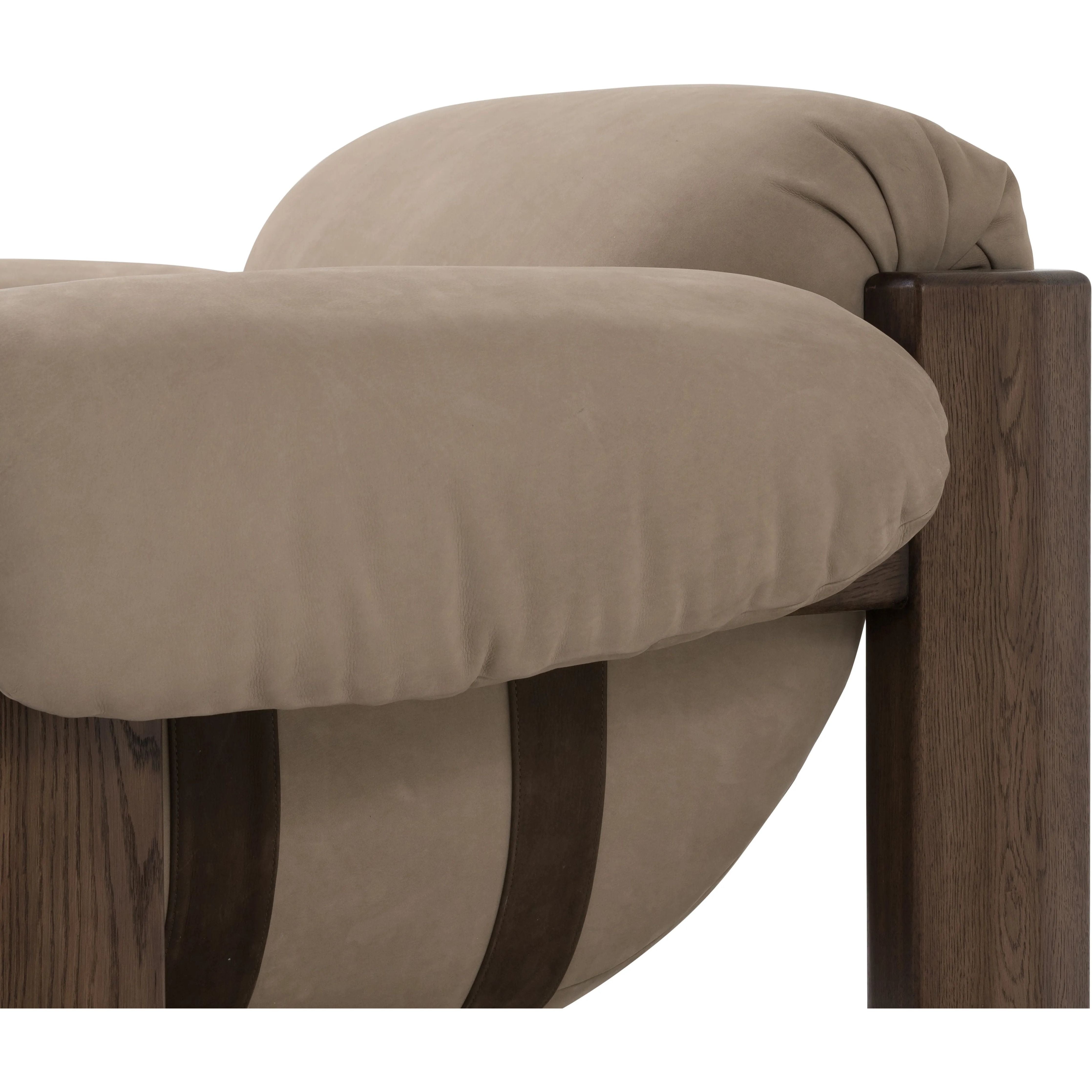 Featuring Samena Nubuck Sand Chair by Four Hands at Amethyst Home. A cozy spot for lounging and curling up with a good book. This statement-making chair features large overflowing cushioning that wraps around the arms and back. Designed with S spring construction and a solid oak frame. Upholstered in a smooth sueded leather with contrasting sling seating strap . Amethyst Home provides interior design, new home construction design consulting, vintage area rugs, and lighting in the Tampa metro area.