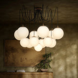 Featuring Spider Burnished Brass Opal Matte Glass Cord Chandelier by Four Hands at Amethyst Home. Matte glass spheres float at varying lengths for a statement-making piece. Each globe is individually blown, shaped and sculpted by hand through a one-hour process. Matte glass is specially manufactured to evenly diffuse light. Brass and glass are 98% recyclable. D. Amethyst Home provides interior design, new home construction design consulting, vintage area rugs, and lighting in the Miami metro area.