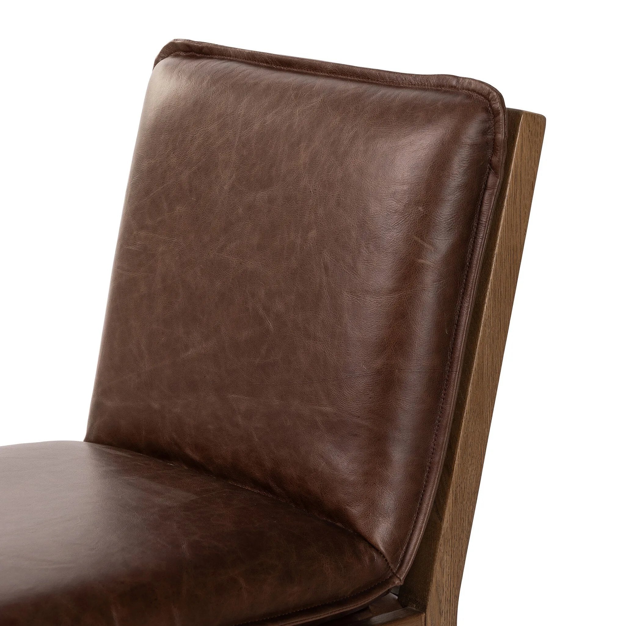 Featuring Wilmington Tan Oak Dining Chair by Four Hands at Amethyst Home. Inspired by the folded pillow form, the seat and back cushions of this oak dining chair are covered in brown top-grain leather. The chair back features leather strap details for a mixed material touch.Collection: AshfordColors: Tan Oak ,Havana BrownMaterials: Solid Oak ,Top Grain Leathe. Amethyst Home provides interior design, new home construction design consulting, vintage area rugs, and lighting in the Houston metro area.