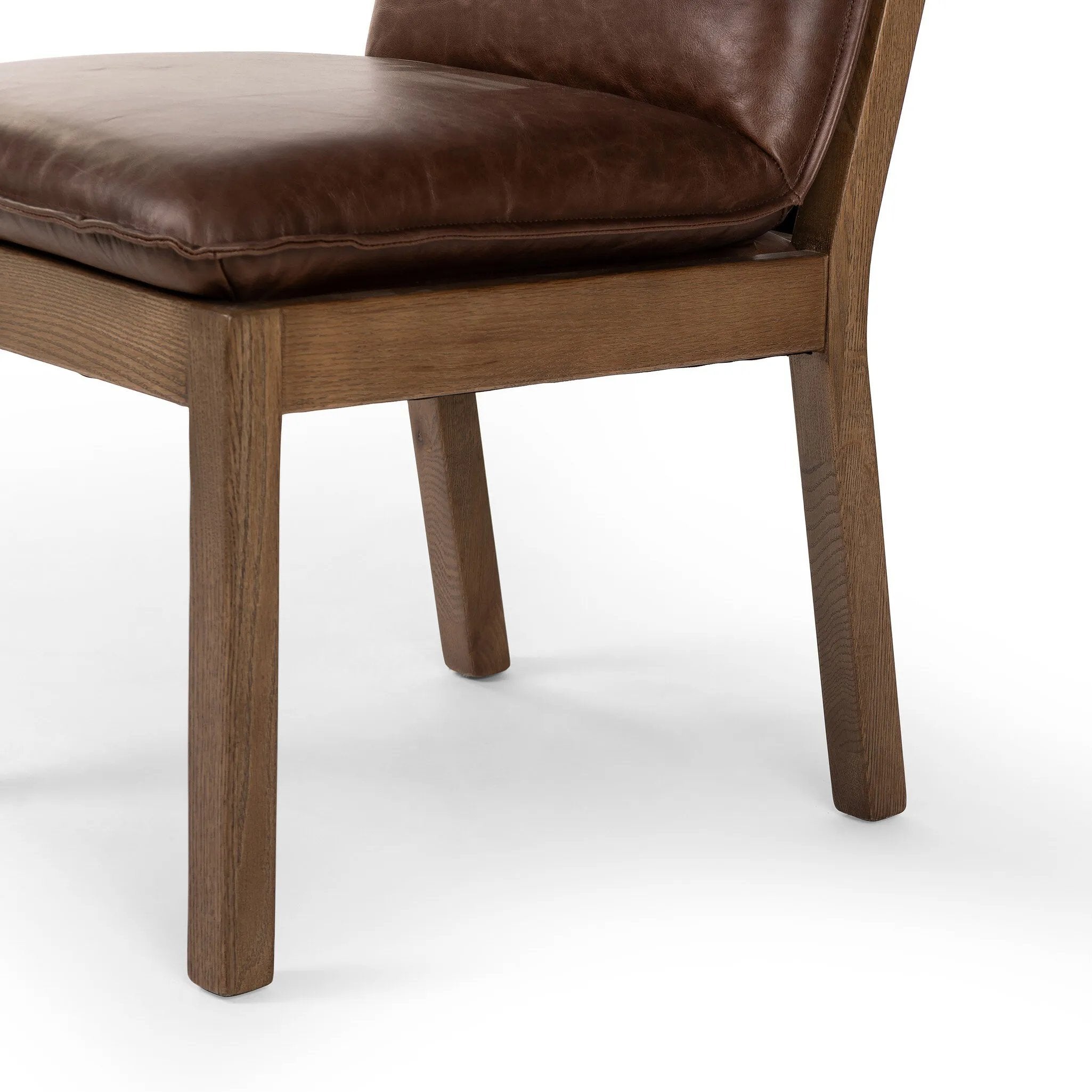 Featuring Wilmington Tan Oak Dining Chair by Four Hands at Amethyst Home. Inspired by the folded pillow form, the seat and back cushions of this oak dining chair are covered in brown top-grain leather. The chair back features leather strap details for a mixed material touch.Collection: AshfordColors: Tan Oak ,Havana BrownMaterials: Solid Oak ,Top Grain L. Amethyst Home provides interior design, new home construction design consulting, vintage area rugs, and lighting in the Laguna Beach metro area.