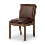 Featuring Wilmington Tan Oak Dining Chair by Four Hands at Amethyst Home. Inspired by the folded pillow form, the seat and back cushions of this oak dining chair are covered in brown top-grain leather. The chair back features leather strap details for a mixed material touch.Collection: AshfordColors: Tan Oak ,Havana BrownMaterials: Solid Oak ,Top Grain Leat. Amethyst Home provides interior design, new home construction design consulting, vintage area rugs, and lighting in the San Diego metro area.
