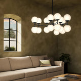 Featuring Zodiac Black Gunmetal Chandelier by Four Hands at Amethyst Home. Matte glass spheres seem to extend and reach across smooth brass rods. Each globe is individually blown, shaped and sculpted by hand through a one-hour process. Matte glass is specially manufactured to evenly diffuse light. The finish on the brass frame is achieved through a specia. Amethyst Home provides interior design, new home construction design consulting, vintage area rugs, and lighting in the Kansas City metro area.