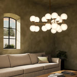 Featuring Zodiac Burnished Brass Chandelier by Four Hands at Amethyst Home. Matte glass spheres seem to extend and reach across smooth brass rods. Each globe is individually blown, shaped and sculpted by hand through a one-hour process. Matte glass is specially manufactured to evenly diffuse light. Brass and glass are 98% recyclable. Designed and sustain. Amethyst Home provides interior design, new home construction design consulting, vintage area rugs, and lighting in the Laguna Beach metro area.