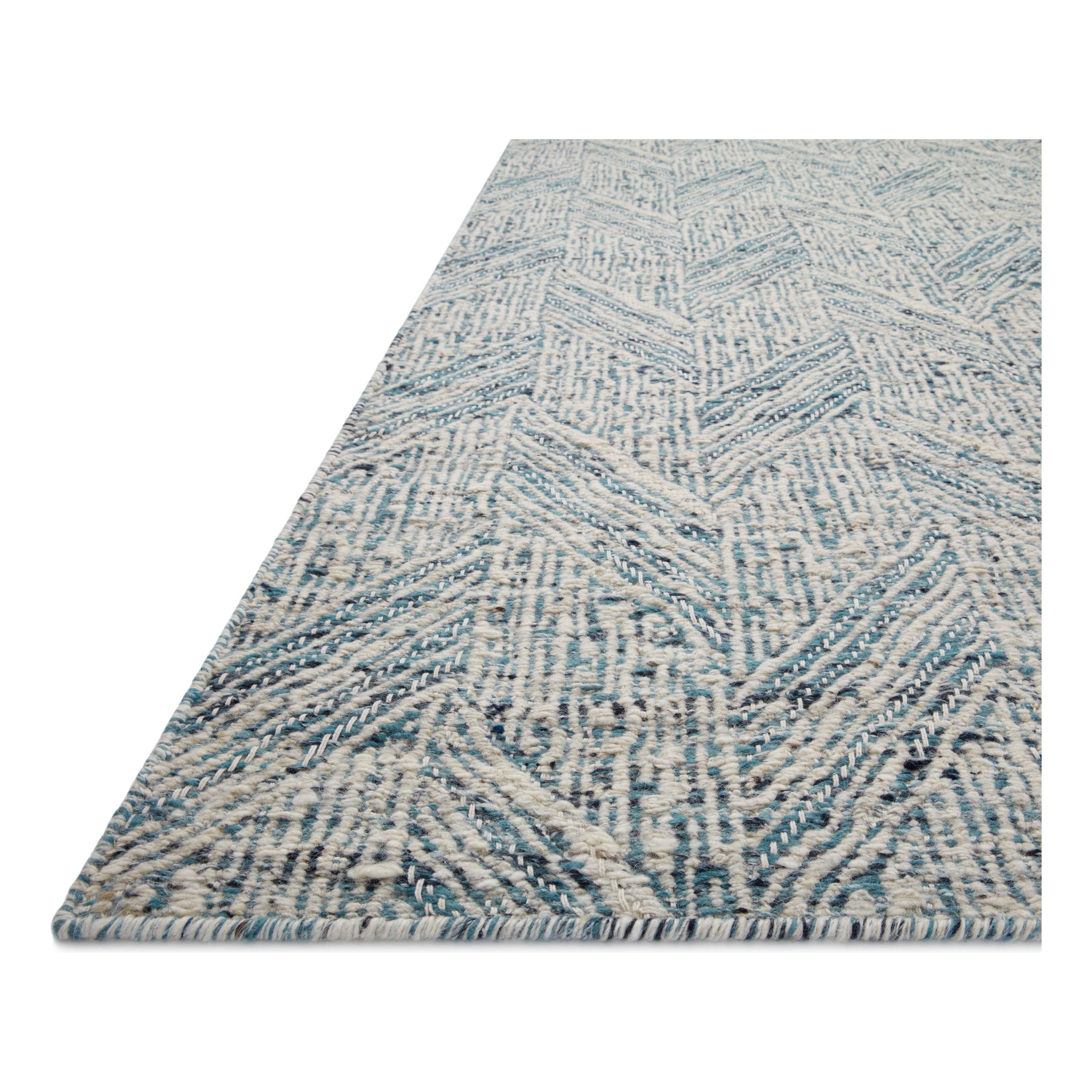 Featuring Raven Blue / Ivory Rug by Loloi at Amethyst Home. The Raven Blue / Ivory Rug is intricately handwoven with delicate, fine yarns that amplify the rug's layered and dimensional geometric design. While the rug itself is thick and sturdy, the colors and patterns have a casual lightness that can work in many spaces, from busy living rooms to serene bedrooms. The Raven Bl. Amethyst Home provides interior design, new construction, custom furniture, and area rugs in the Newport Beach metro area.
