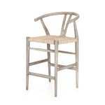 Featuring Muestra Counter + Bar Stool - Weathered Grey by Four Hands at Amethyst Home. Modern curves redefine the classic wishbone-style counter stool. Vintage white all-weather wicker is woven for a dose of fresh texture within weathered grey teak framing. Cover or store indoors during inclement weather and when not in use.
Counter Stool Overall Size: 21.  Amethyst Home provides interior design, new home construction design consulting, vintage area rugs, and lighting in the Washington metro area.