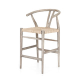 Featuring Muestra Counter + Bar Stool - Weathered Grey by Four Hands at Amethyst Home. Modern curves redefine the classic wishbone-style counter stool. Vintage white all-weather wicker is woven for a dose of fresh texture within weathered grey teak framing. Cover or store indoors during inclement weather and when not in use.
Counter Stool Overall Size: 21.  Amethyst Home provides interior design, new home construction design consulting, vintage area rugs, and lighting in the Washington metro area.