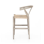 Featuring Muestra Counter + Bar Stool - Weathered Grey by Four Hands at Amethyst Home. Modern curves redefine the classic wishbone-style counter stool. Vintage white all-weather wicker is woven for a dose of fresh texture within weathered grey teak framing. Cover or store indoors during inclement weather and when not in use.
Counter Stool Overall Size: 21..  Amethyst Home provides interior design, new home construction design consulting, vintage area rugs, and lighting in the San Diego metro area.