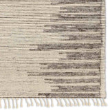 Featuring Alpine Patra Hand-Knotted Rug by Jaipur Living at Amethyst Home. Inspired by textiles from the Tullu region in Morocco, the Patra area rug showcases a linear design in neutral shades of cream, taupe, brown, and gray. This high-piled accent lends warmth and comfort to any space with durable wool hand-knotted onto a cotton foundation. Braided fringe. Amethyst Home provides interior design, new home construction design consulting, vintage area rugs, and lighting in the Charlotte metro area.
