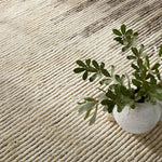 Featuring Alpine Patra Hand-Knotted Rug by Jaipur Living at Amethyst Home. Inspired by textiles from the Tullu region in Morocco, the Patra area rug showcases a linear design in neutral shades of cream, taupe, brown, and gray. This high-piled accent lends warmth and comfort to any space with durable wool hand-knotted onto a cotton foundation. Braided fri. Amethyst Home provides interior design, new home construction design consulting, vintage area rugs, and lighting in the Laguna Beach metro area.