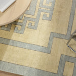 Featuring Cyprus Nicosia Asparagus Hand-Knotted Rug by Jaipur Living at Amethyst Home. The hand-knotted Cyprus collection showcases a modern representation of vintage Kars designs with clean-lined geometric details and fresh colorways. The blue, cream, gray, and caramel colored Nicosia design delights with a minimalistic medallion pattern and multiple borders. Low pile and na. Amethyst Home provides interior design, new construction, custom furniture, and area rugs in the Newport Beach metro area.