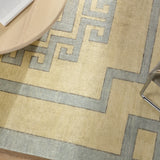 Featuring Cyprus Nicosia Asparagus Hand-Knotted Rug by Jaipur Living at Amethyst Home. The hand-knotted Cyprus collection showcases a modern representation of vintage Kars designs with clean-lined geometric details and fresh colorways. The blue, cream, gray, and caramel colored Nicosia design delights with a minimalistic medallion pattern and multiple borders. Low pile and na. Amethyst Home provides interior design, new construction, custom furniture, and area rugs in the Newport Beach metro area.