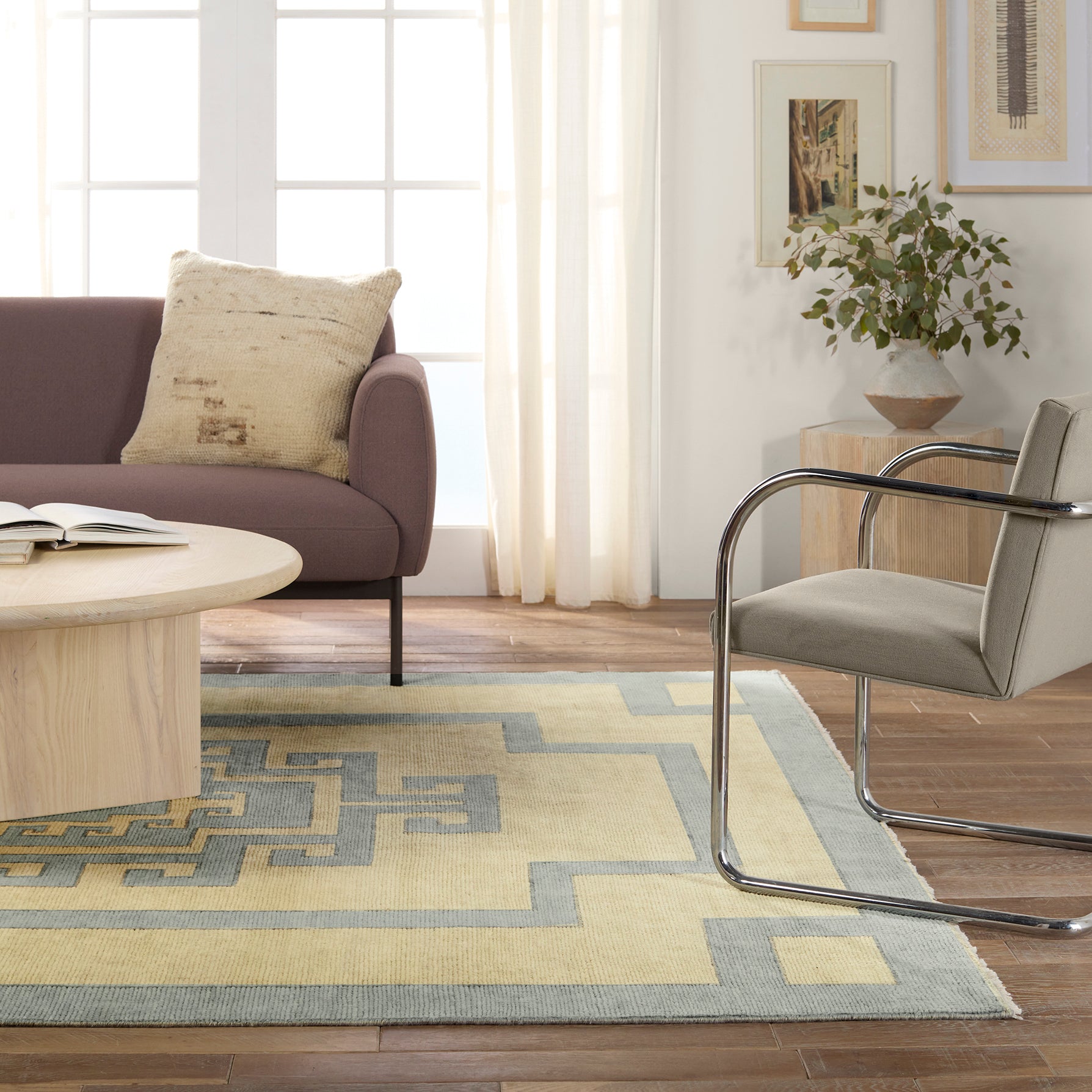 Featuring Cyprus Nicosia Asparagus Hand-Knotted Rug by Jaipur Living at Amethyst Home. The hand-knotted Cyprus collection showcases a modern representation of vintage Kars designs with clean-lined geometric details and fresh colorways. The blue, cream, gray, and caramel colored Nicosia design delights with a minimalistic medallion pattern and multiple borders. Low pile and naturall. Amethyst Home provides interior design, new construction, custom furniture, and area rugs in the Seattle metro area.