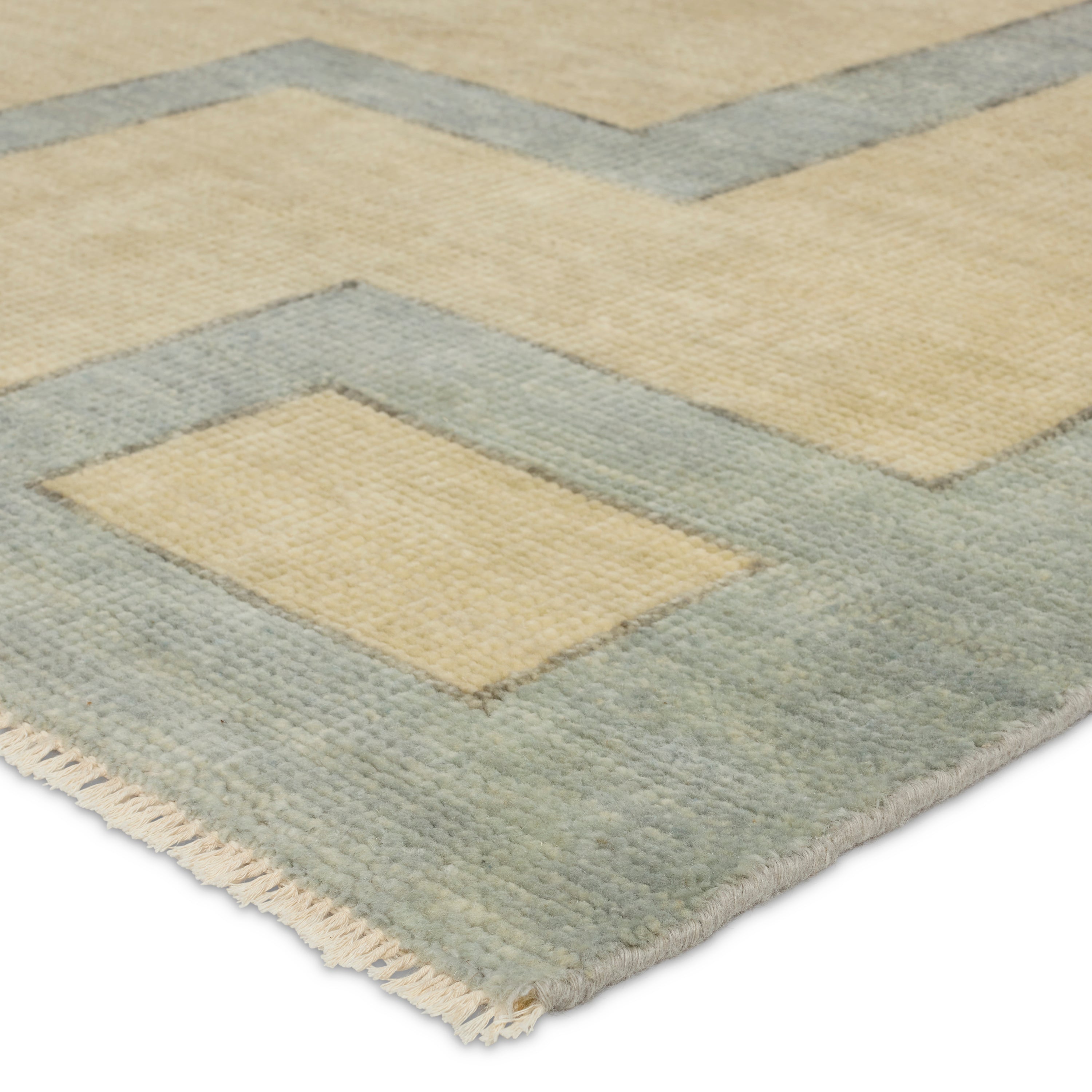 Featuring Cyprus Nicosia Asparagus Hand-Knotted Rug by Jaipur Living at Amethyst Home. The hand-knotted Cyprus collection showcases a modern representation of vintage Kars designs with clean-lined geometric details and fresh colorways. The blue, cream, gray, and caramel colored Nicosia design delights with a minimalistic medallion pattern and multiple borders. Low pile and naturally . Amethyst Home provides interior design, new construction, custom furniture, and area rugs in the Tampa metro area.