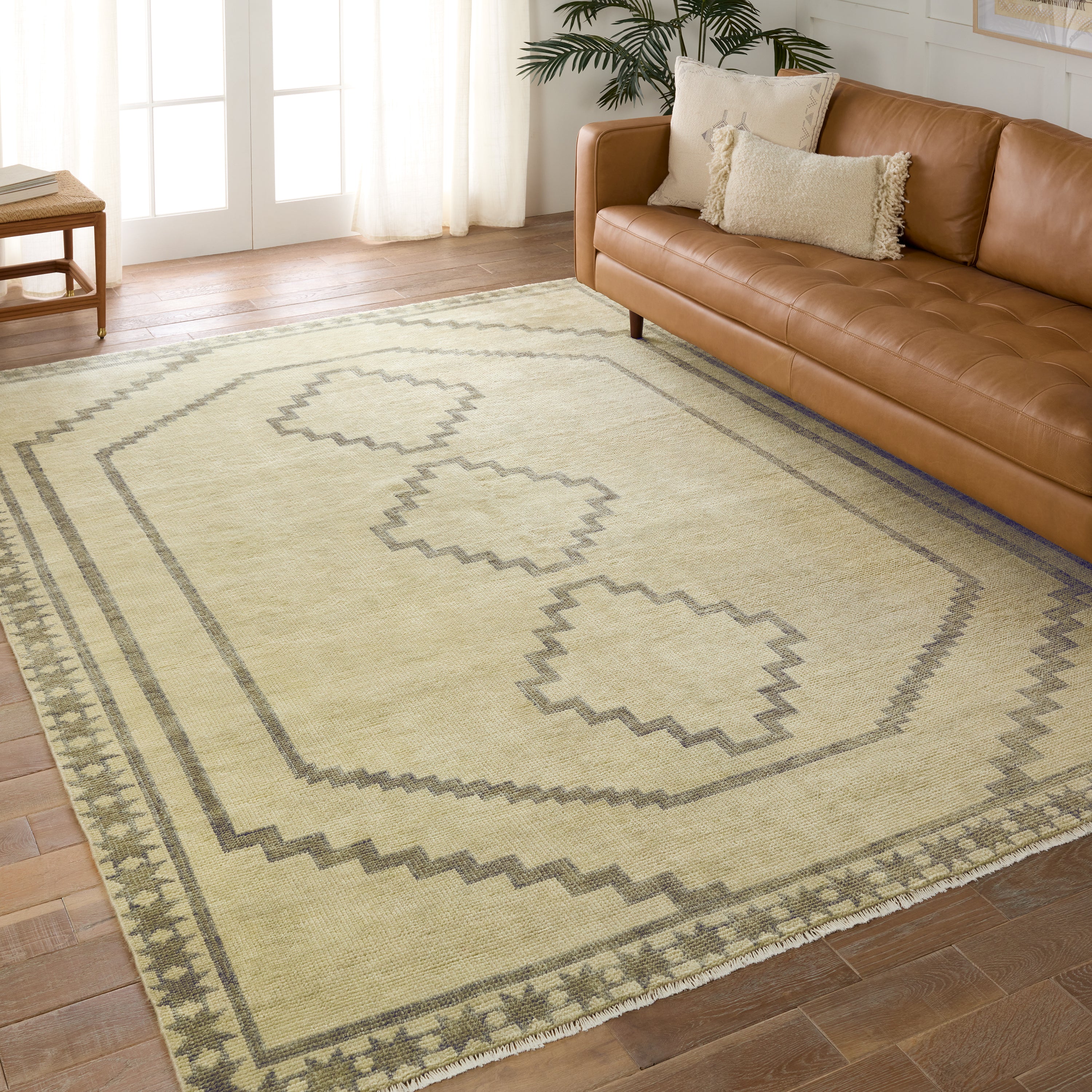Featuring Cyprus Green Paphos Hand-Knotted Rug by Jaipur Living at Amethyst Home. The hand-knotted Cyprus collection showcases a modern representation of vintage Kars designs with clean-lined geometric details and fresh colorways. The dark and light green Paphos design delights with a minimalistic medallion pattern and a similarly styled border. Low pile and naturally stain resistan. Amethyst Home provides interior design, new construction, custom furniture, and area rugs in the Boston metro area.