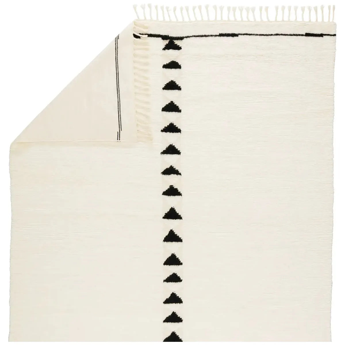 Featuring Desouk Vendace Rug by Jaipur Living at Amethyst Home. The Desouk collection melds modern allure with the global vibes of Morocco. The Vendace hand-knotted rug showcases a geometric linear pattern with contrasting black and cream tones. This handcrafted rug boasts plush, cut wool pile that pairs beautifully with braided tassel details. Perfect for adding warmth to cozy bedrooms an. Amethyst Home provides interior design services, furniture, rugs, and lighting in the Des Moines metro area.