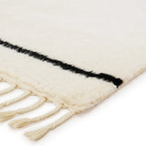 Featuring Desouk Vendace Rug by Jaipur Living at Amethyst Home. The Desouk collection melds modern allure with the global vibes of Morocco. The Vendace hand-knotted rug showcases a geometric linear pattern with contrasting black and cream tones. This handcrafted rug boasts plush, cut wool pile that pairs beautifully with braided tassel details. Perfect for adding warmth to cozy bedrooms and sit. Amethyst Home provides interior design services, furniture, rugs, and lighting in the Miami metro area.
