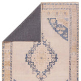 Featuring Lumal Debolo Rug by Jaipur Living at Amethyst Home. Distressed, vintage designs offer an elevated tone for the Lumal Collection. The Debolo rug features a vintage-inspired medallion, geometric border, and floral detailing in tones of tan, blue, yellow, and gray. This machine washable rug is stain resistant and easy to clean, perfect for homes with ch. Amethyst Home provides interior design, new home construction design consulting, vintage area rugs, and lighting in the Dallas metro area.